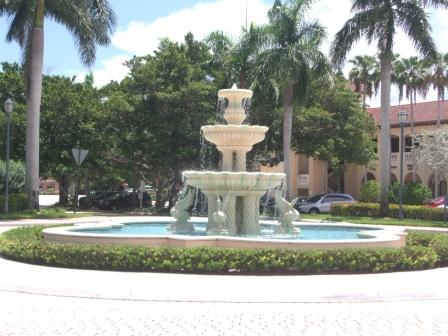 Large fountain in courtyard area surrounded by small bushes